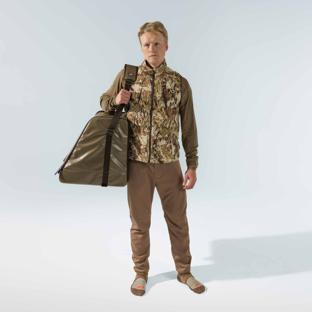 Shiny olive green triangular duffel bag with a top zipper closure and dark brown shoulder strap.