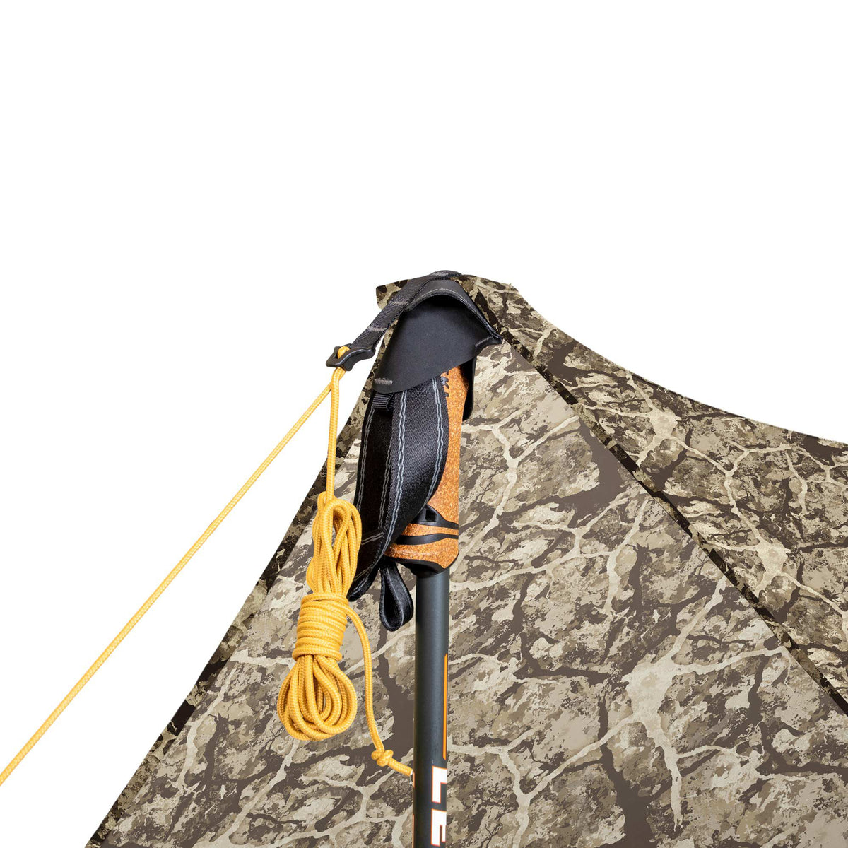 Close-up of a camouflage tent peak supported by a black trekking pole with a cork handle, with a coiled yellow guideline.