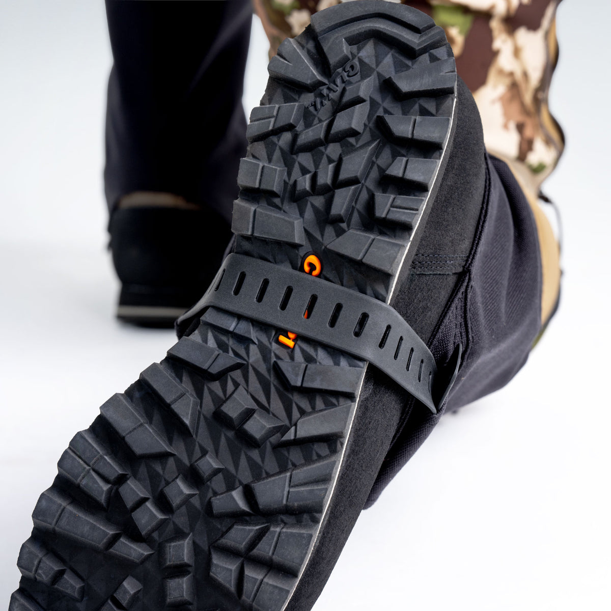 Close up of hunting boot bottom with boot gaiter strap