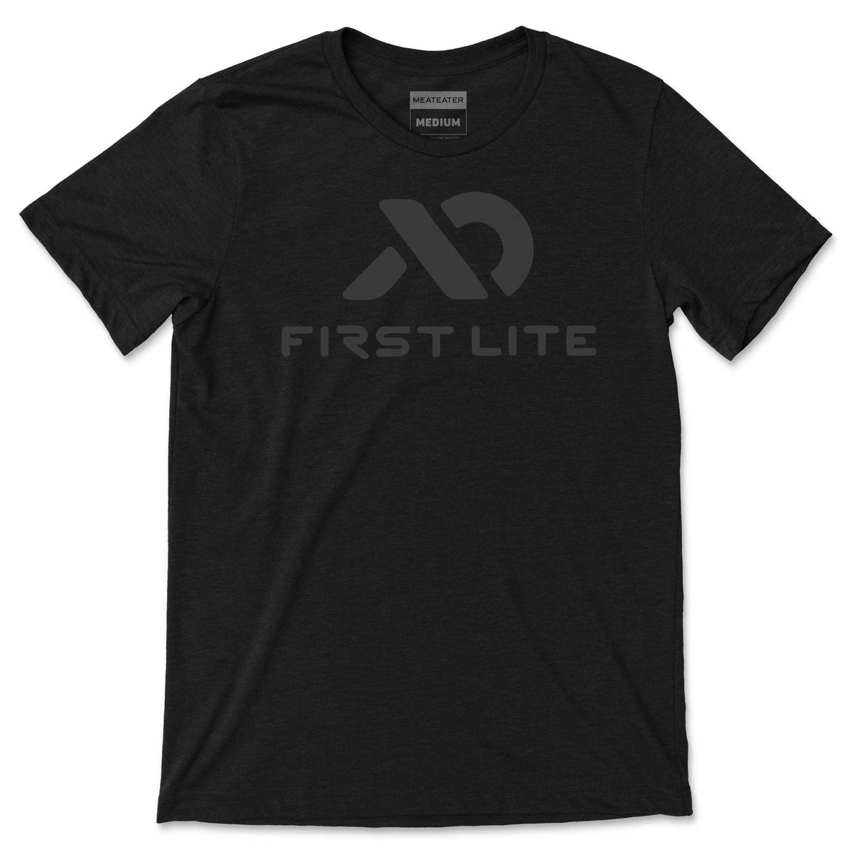 Black heather t-shirt with a dark gray First Lite logo and text on the front, and a MeatEater Medium tag visible at the neck.