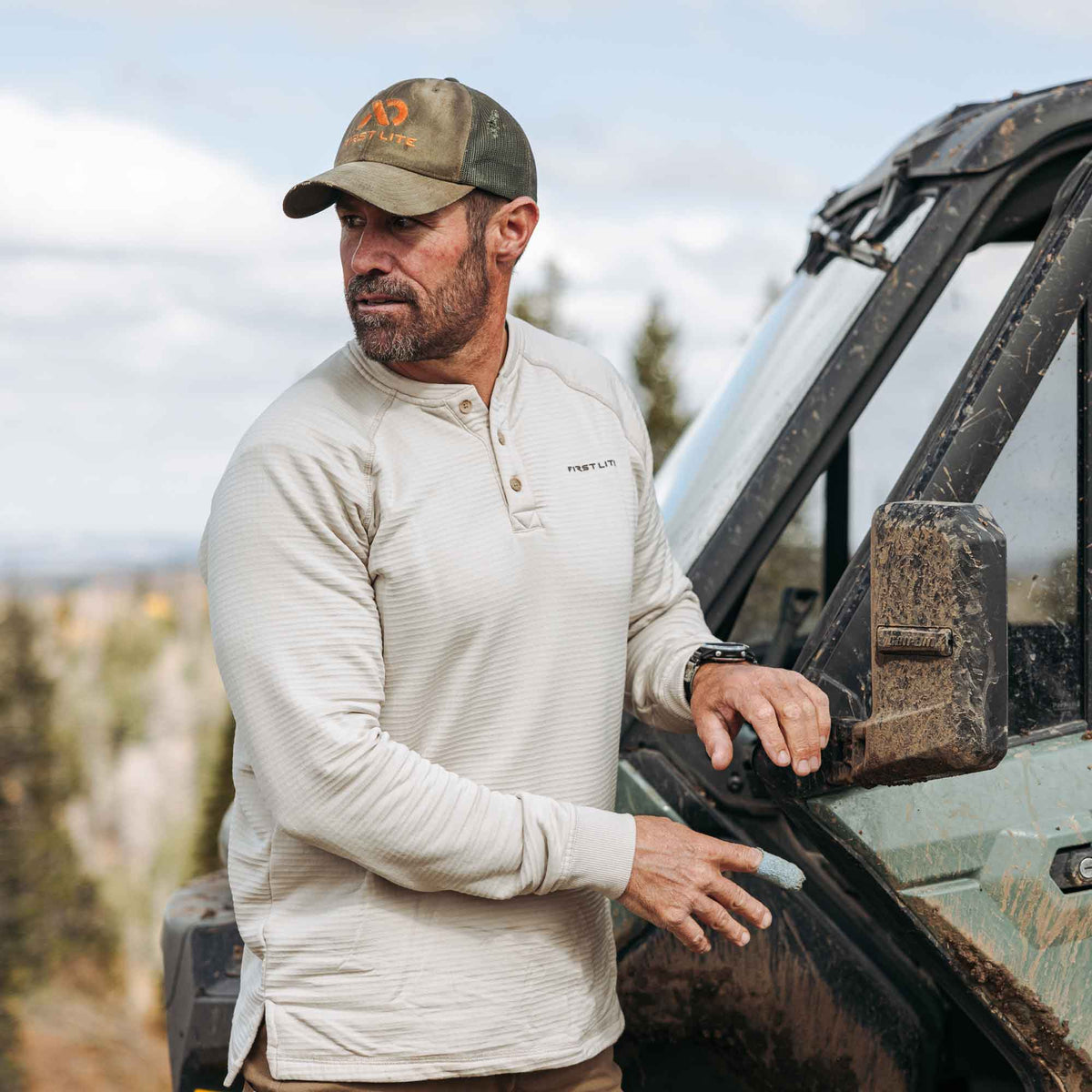 Light tan ribbed long-sleeve henley shirt with a three-button placket and First Lite logo.