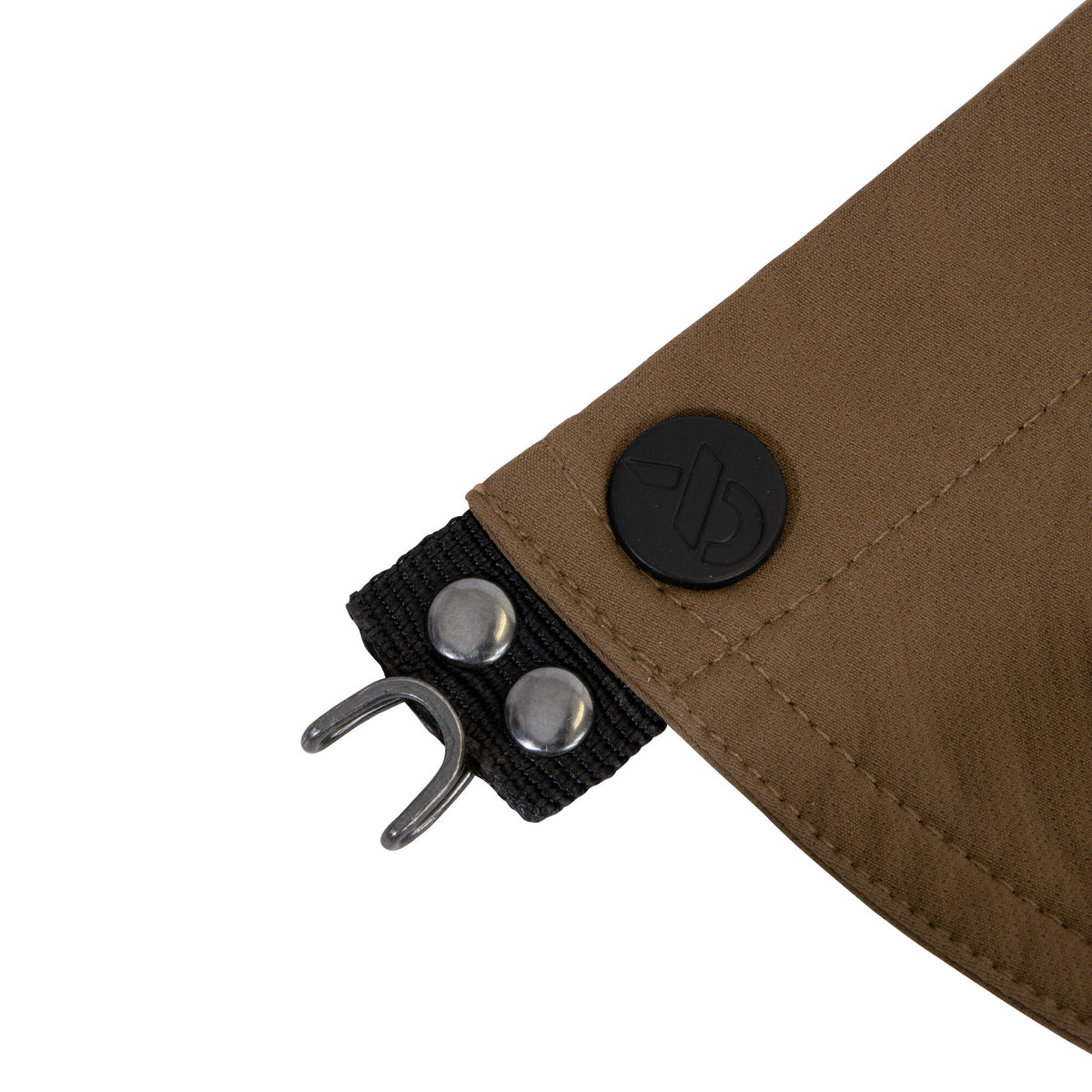 Textured brown fabric panel with black webbing, two silver snap buttons, a metal hook, and a black circular logo button.