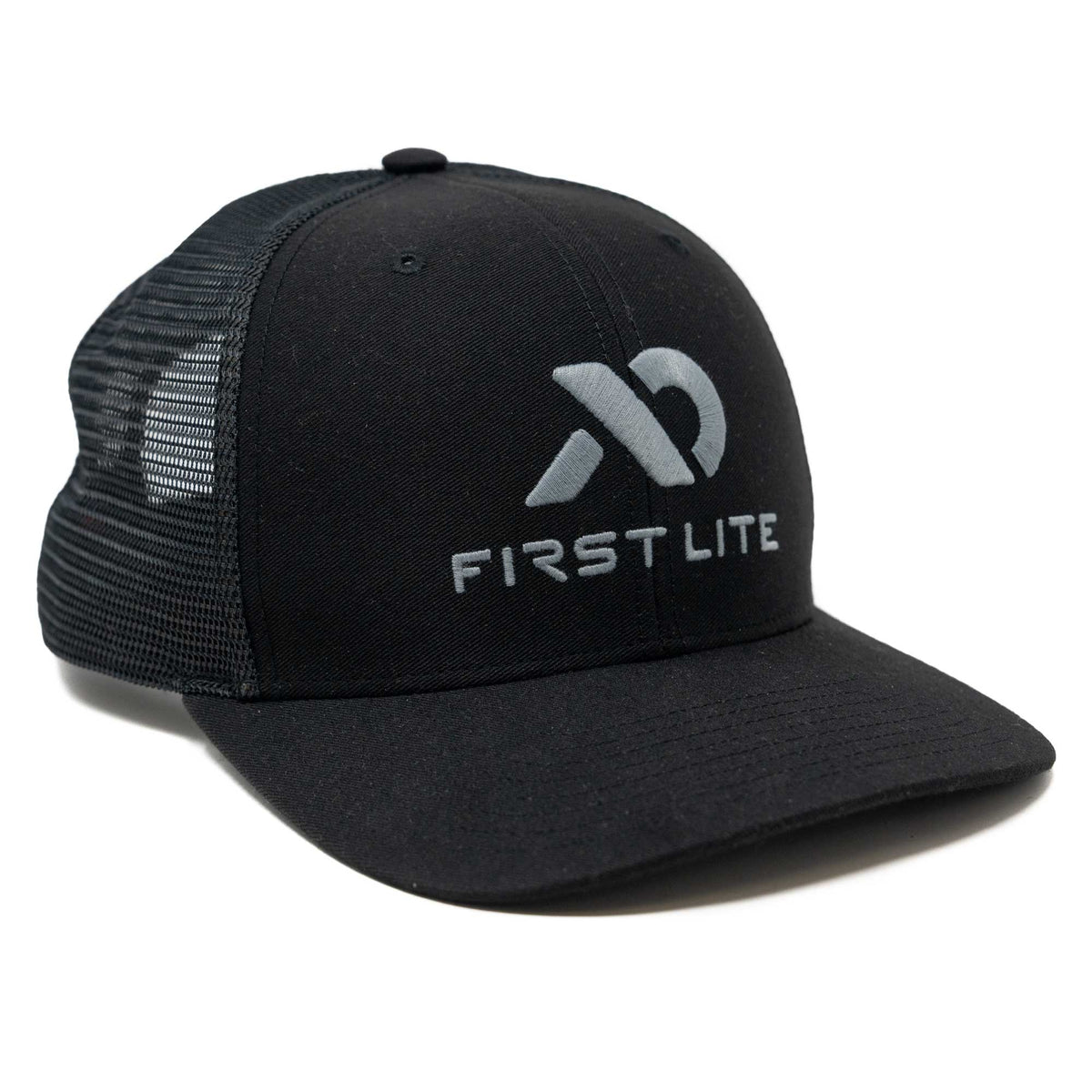 Black trucker cap with a grey First Lite logo on the front and mesh back.