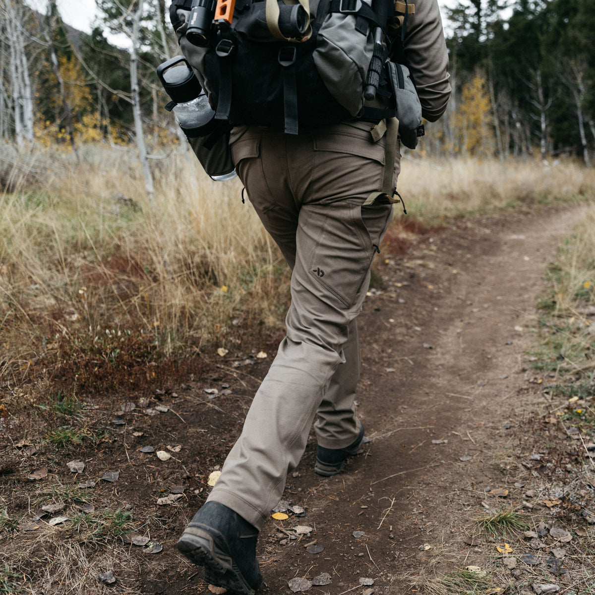 Olive brown tactical pants with cargo pockets and a logo on the left thigh.