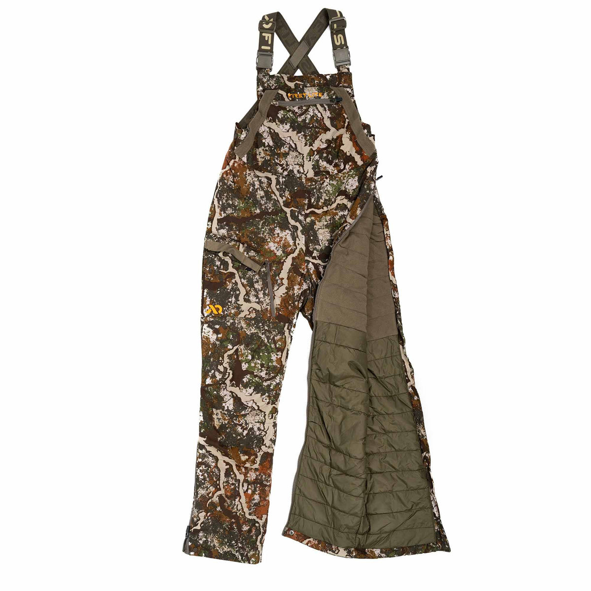 First Lite camouflage hunting bib overalls with full side zippers open, revealing a quilted olive lining.