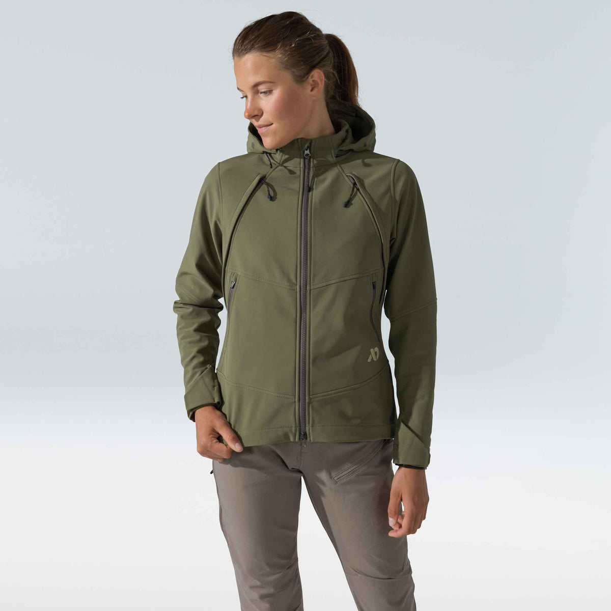 Women's olive green hooded softshell jacket with a full front zipper, two zippered chest pockets, and a subtle logo on the chest.