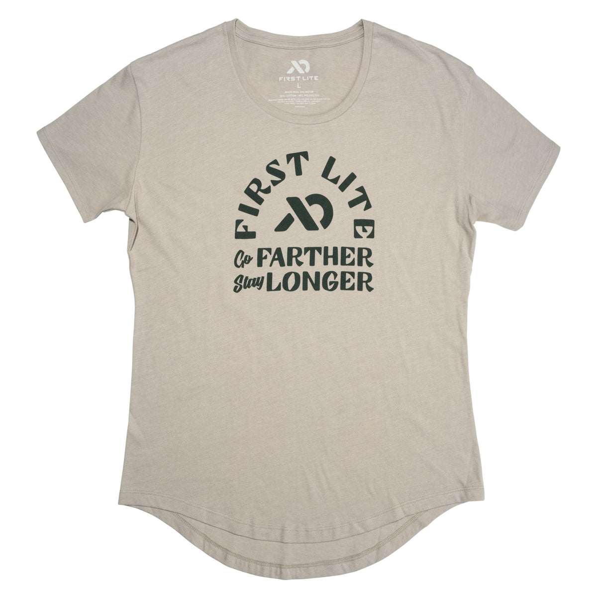 A light tan short-sleeve t-shirt with a crew neck, curved hem, and a dark green "FIRST LITE Go FARTHER Stay LONGER" graphic on the front.